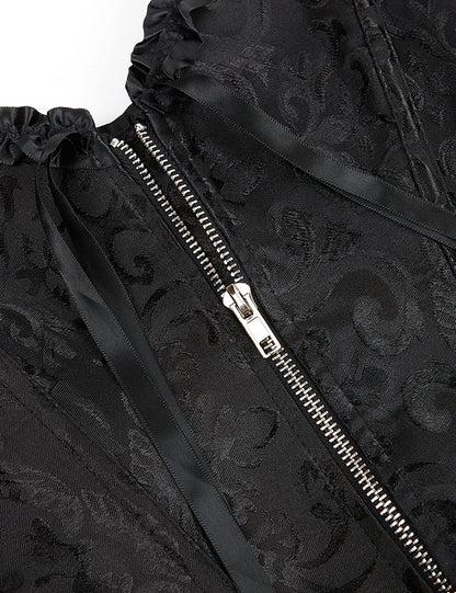 Nahaufnahme schwarzer Damen-Corsage mit floraler Broschierung, silbernem Reißverschluss und Schmalbändern.